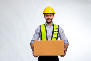 Delivery man employee in yellow hard hat hold cardboard box isolated on white background. Delivery man holding cardboard boxes. Smiling delivery man standing on white background