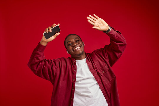 emotional man african appearance with phone in hands technology communication joy