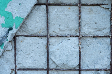 Texture of old concrete wall with rusty fittings and green paint
