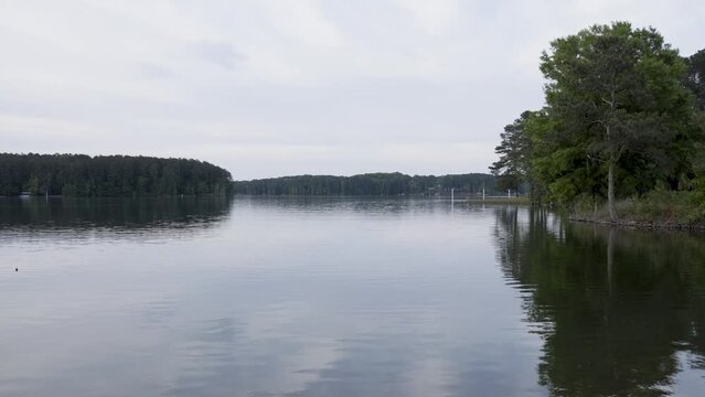 footage of a gorgeous spring landscape at Proctor Landing Park at sunset with rippling water surrounded by lush green trees and plants and at Lake Acworth in Acworth Georgia USA