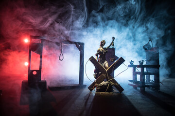Execution concept. Death penalty electric chair miniature in selective focus inside old prison. Old prison bars cell lock. Creative artwork decoration. Electric chair scale model in the dark - obrazy, fototapety, plakaty