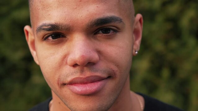 nice-looking Afro-American boy posing for the camera, closeup outdoors. High quality 4k footage