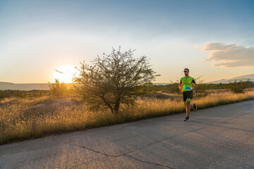 Obraz premium Triathlete in professional gear running early in the morning, preparing for a marathon, dedication to sport and readiness to take on the challenges of a marathon. 