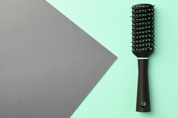 Fototapeta premium Stylish hairbrush on color background, top view. Space for text