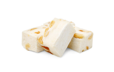 Many pieces of delicious nougat on white background
