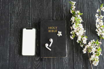 Study Bible worship online concept. Church online Sunday new normal concept. Bible, cell phone and...