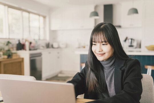 Young adult Asian woman working from home, distance learning, online teaching, video conference concept