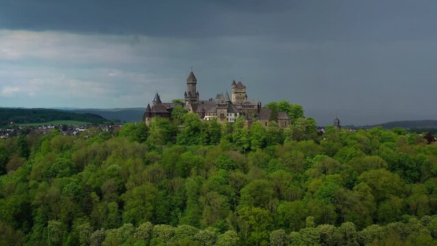 Aerial drone view medieval neo-gothic Braunfels castle on top of hill on gloomy rainy day. Hessen, Germany. High quality 4k footage