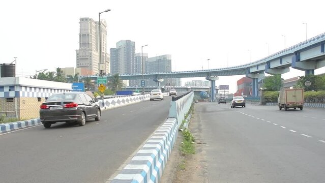 14th May, 2023, Kolklata, West Bengal, India: Early morning traffic movement on Eastern Metropolitan Bypass and Maa bridge with beautiful cityscape of Kolkata.