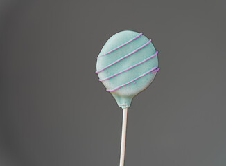 Colorful homemade cake pop on gray background