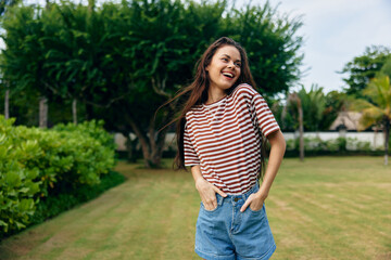 long woman t-shirt lifestyle hair walk nature park smiling freedom summer beautiful