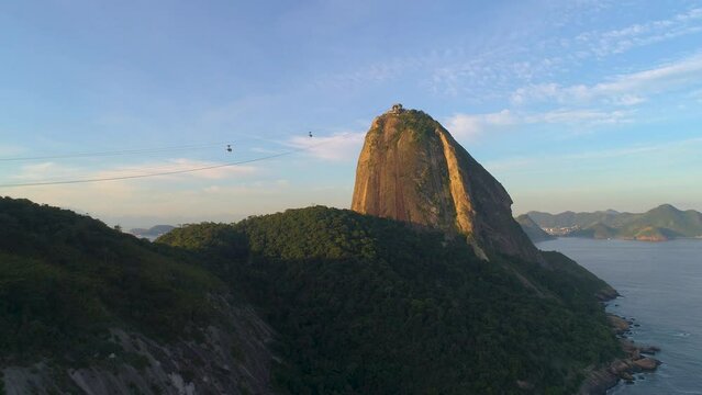 RIO DE JANEIRO, BRAZIL- MAY 2023: Aerial drone video of Sugarloaf Mountain and Urca neighborhood, Atlantic ocean coast at sunset from above.