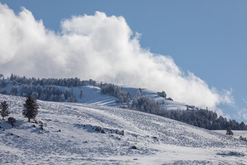 Yellowstone Backcountry in Winter with low clouds engulfing the mountain ridges
