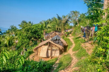 A small village of thatched huts in an indigenous Mangyan tribal community on a hillside on Mindoro Island, Philippines. The small homes have no electricity or running water.