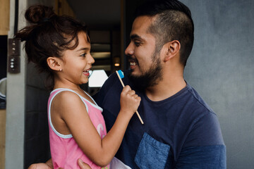 latin young father teaching to his daughter how to brush teeth at home in Mexico Latin America, hispanic family  - obrazy, fototapety, plakaty