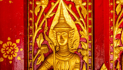 Golden fresco at Wat Hosian Voravihane Buddhist Temple in Luang Prabang Laos
