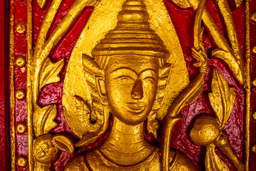 Golden fresco at Wat Hosian Voravihane Buddhist Temple in Luang Prabang Laos