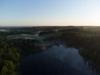 Fototapeta na wymiar Majestic Morning: A Drone's Eye View of a Misty Lake in the Woods at Sunrise in Northern Europe