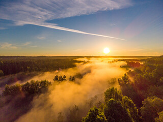 Drone's Eye View: Serene Sunrise Over Misty River and Woodland Landscape in Northern Europe