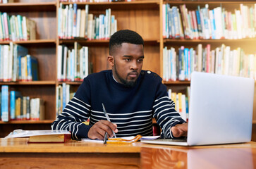 University. library and student on laptop with research, planning or learning for exam, report or focus on studying, goals and education. Black man, college and working on task, essay or scholarship - obrazy, fototapety, plakaty