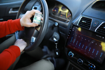 Obraz premium dollars with a car key lie in inside cars. financial concept