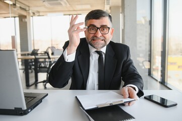 Angry businessman with document shouting at somebody