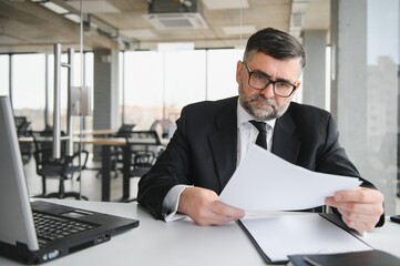 Fototapeta premium Angry businessman with too much work in office