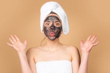Facial charcoal mask. Cosmetics, cosmetology, dermatology. Woman face with black clay mask....