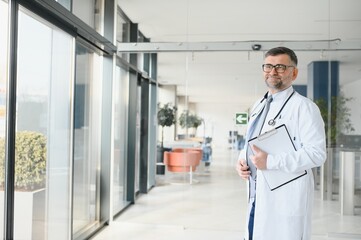 Portrait of senior doctor in white coat