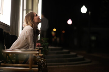 Girl sitting in a cafe at night