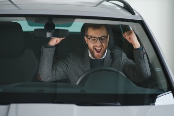 His true love. Portrait of a mature man smiling happily sitting in a brand new car