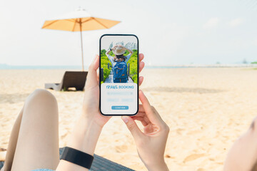 Woman sitting on deckchair on the beach using smartphone with application booking flight travel search ticket holiday and hotel on website, concept technology online marketing and promotion.