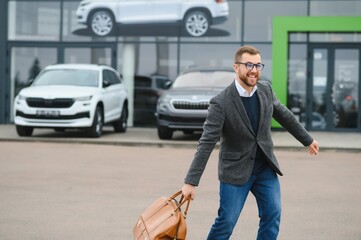 Portrait of happy customer buying new car.