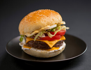 Big tasty burger with beef cutlet on a black background