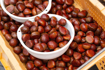 Raw chestnuts on display in a traditional market