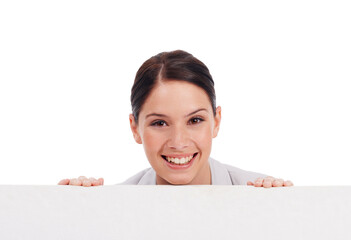 Portrait, mockup board and woman peeking over in studio isolated on a white background. Face, poster and happy female person with copy space, advertising and marketing, promotion and commercial.