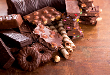 Sweets with nuts and chocolate. gingerbread cookies and chocolate on a wooden background