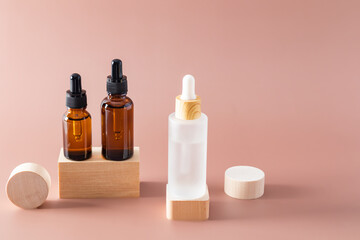 Luxurious cosmetic bottles with anti-aging skin care products for the face and body stand on wooden geometric shapes, catwalks. Product presentation.