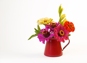 small bouquet of summer flowers in a red vase isolated on a white background