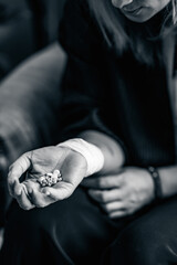 Woman with bunch of pills in hand.