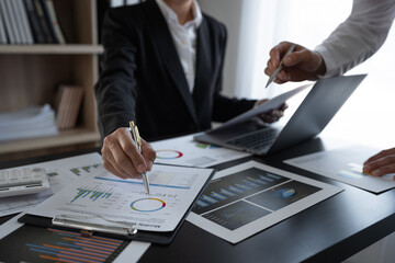 business team brainstorming Discuss the data on earnings charts and financial growth graphs....