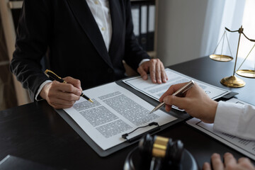 Businessmen and lawyers or legal advisors discuss legal treaty contract documents before signing contract business.