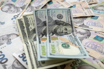 Ukrainian hryvnia with American dollars as business background