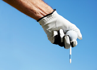 Golf ball, tee and hands of man on blue sky for contest, competition challenge and summer training...