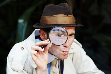 Private investigator, eye in magnifying glass and portrait of man for detective, searching and...