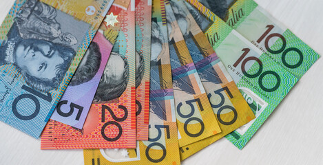 Australian dollars in fan on wooden table, closeup
