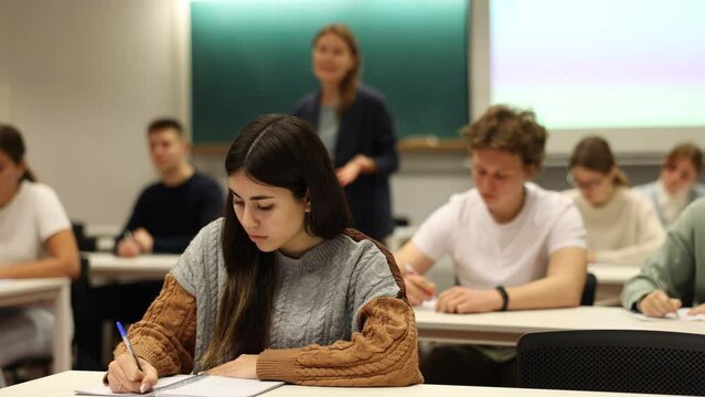 Portrait of a female student recording a lecture at a lesson