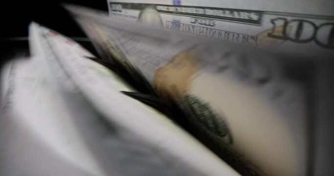 Counting dollar bills with special device in equipped bank. Concept of storing and counting money in economic institution macro slow motion