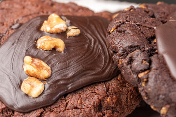 A 'Chocolate Afghan' cookie covered with chocolate topping and pieces of peanut.