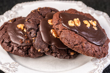 A 'Chocolate Afghan' cookie covered with chocolate topping and pieces of peanut.